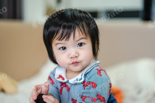 Preview: Fierce little girl with Colorful Cloths over bedroom blurred background, sign and gesture concept.