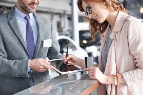 Preview: Salesman using digital tablet to sign in