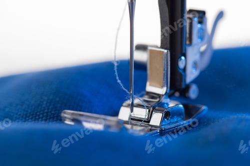 Preview: Close-up view of working sewing machine sewing blue fabric