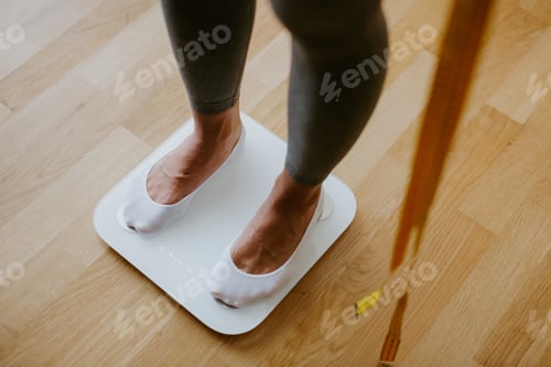 Preview: Woman Measuring Body Weight At Home. weight loss control