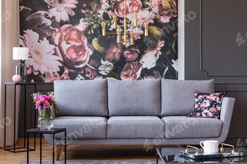 Preview: Flowers on black table and grey sofa in living room interior wit