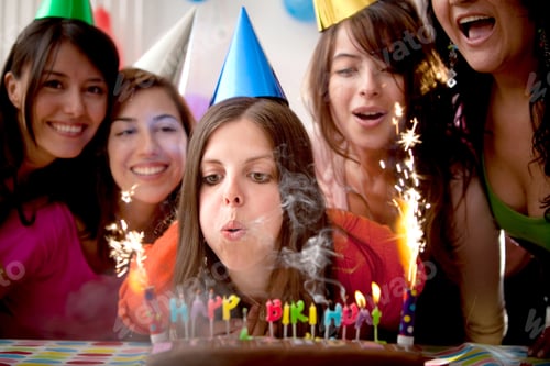Preview: Beautiful Woman Blowing Candles On A Birthday Party With Her Friends