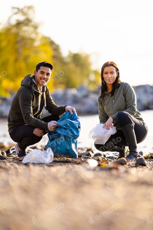 Preview: Portrait of smiling environmental protection volunteers cleaning beach