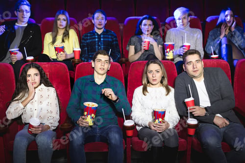 Preview: Group of people watch a horror movie at the cinema