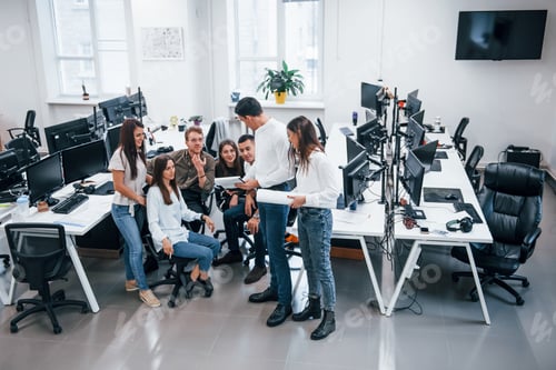 Preview: Group of young business people that standing and sitting and working in the office