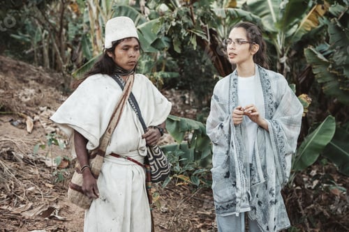 Preview: An Arhuaco Indian in traditional dress and a millennial girl observe a plantation in Colombia.