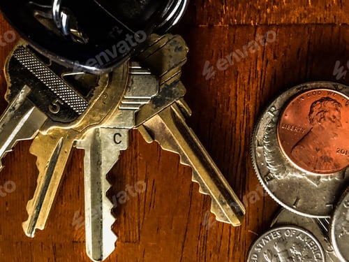 Preview: Spare change and house keys close up.