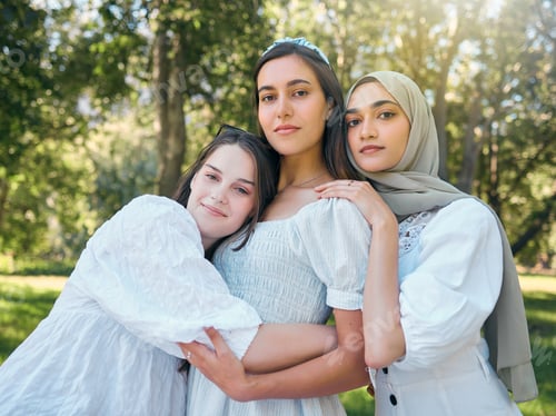 Preview: Group of women hug, show diversity, support and solidarity together, against forrest or garden back