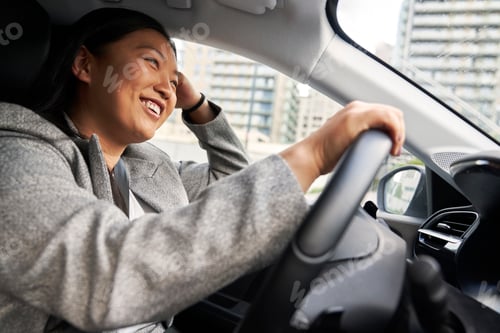 Preview: Chinese woman driving a car with a smile