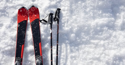 Preview: Mountain skis on bright alpine snow. Winter holidays.
