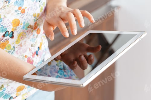 Preview: woman holding digital tablet, closeup