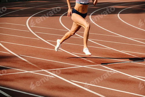 Preview: female athlete running on track of stadium
