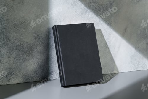 Preview: Black notepad with hard cover on gray background