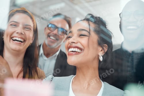 Preview: Shot of a group of businesspeople brainstorming with notes on a glass wall in an office