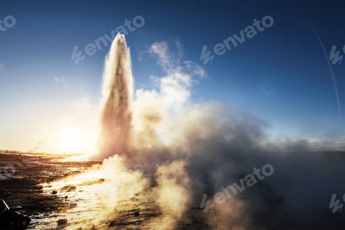 Preview: Eruption of Strokkur geyser in Iceland. Winter cold colors, sun lighting through the steam