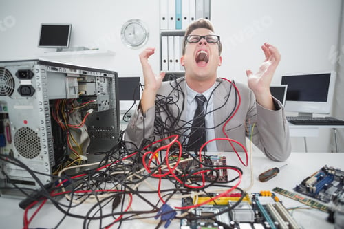 Preview: Stressed Computer Engineer Working On Broken Cables In His Office