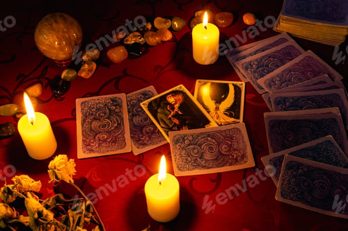Preview: MINSK, BELARUS - November 2021: A fortune teller reads tarot cards and holds cards in her hand.