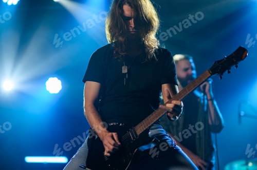 Preview: Guitarist playing electric guitar on stage during concert