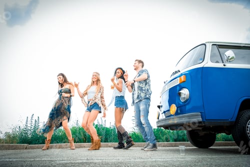 Preview: Happy friends driving a vintage minivan