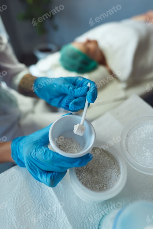 Preview: The process of prep.aration of enzyme peeling for face. Cup in the hands of a beautician