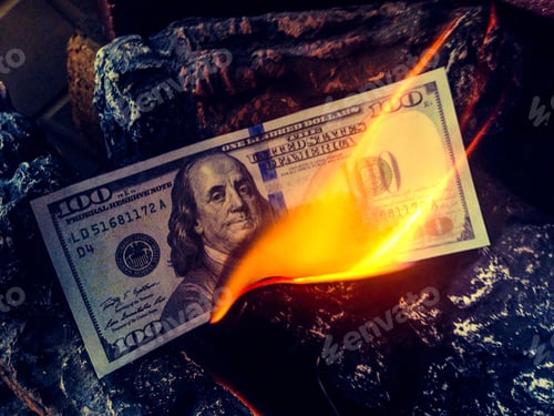 Preview: A $100 bill in a fireplace burning wasting money to burn currency USA finance budget Saving on gas