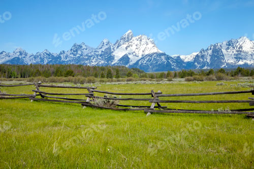 Preview: Old Wood Rail Fence in Field Below Barn in Field Below Grand Teton Mountains