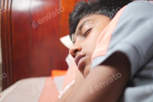 Preview: teenage boy boy sleeping in bed, selective focus .