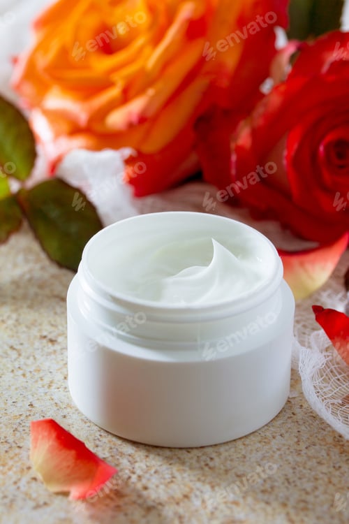 Preview: Face cream with roses on a brown stone fone- beauty salon.