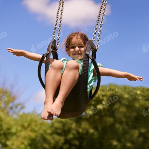 Preview: Nothing better than a swing. Shot of a young girl playing on a swing outsdie.