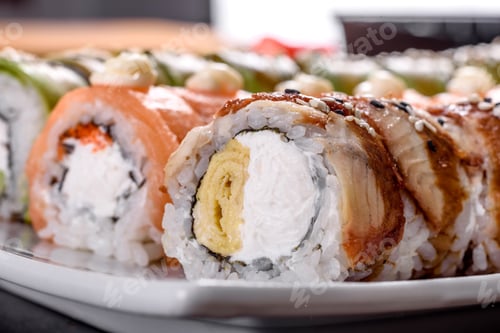 Preview: Fresh tasty sushi rolls laid out in the form of a dragon with ginger and wasabi