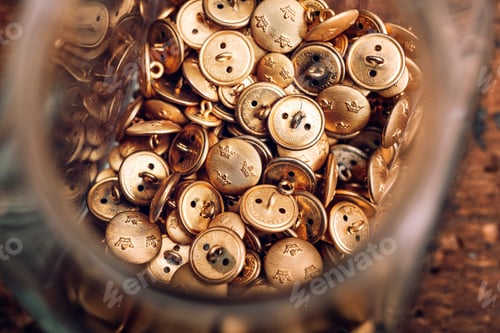 Preview: Directly above shot of jar filled with buttons on table at workshop