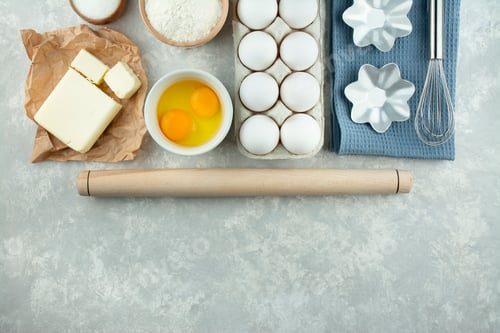 Preview: Ingredients and kitchen utensils for making homemade cakes. Home kitchen. Copy space. Flat lay.