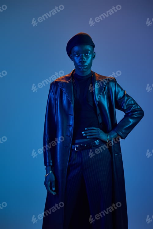 Preview: Stylish young man showcases vibrant fashion against a colorful backdrop