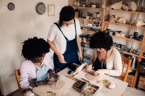 Preview: Diverse creative students learning decorating clay techniques at workshop