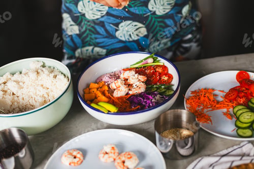Preview: Poke bowl with shrimp prepared by the chef containing white rice, mango, avocado, tomato, etc.