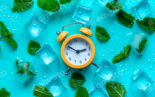 Preview: Clock and ice cubes. Vacation and daylight saving time concept. Selective focus.