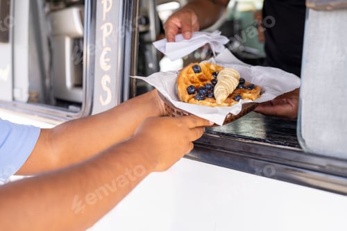 Preview: Buying a delicious waffle with fruits in a food truck