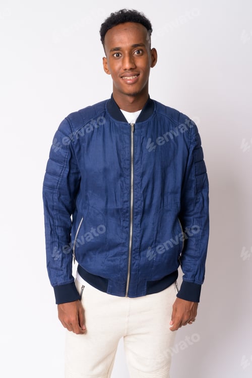 Preview: Young man in blue jacket smiles for camera