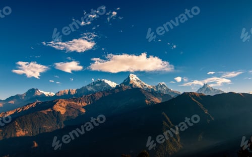 Preview: Snow Capped Mountain Peaks Against a Blue Sky