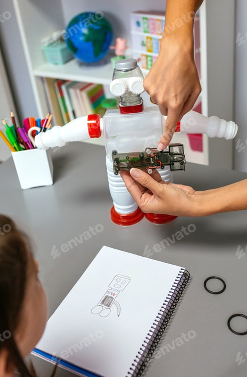 Preview: Teacher explaining how to connect electric circuit on recycled toy robot