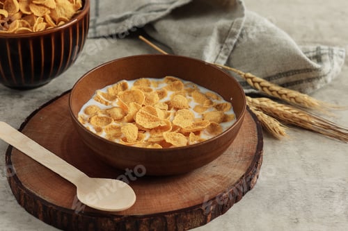 Preview: Breakfast Cereal. Tasty Corn flakes with Milk in Brown Bowl