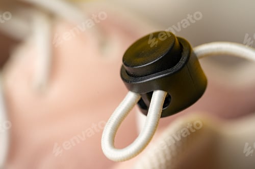 Preview: Drawstring cord stopper on sneaker shoe close up