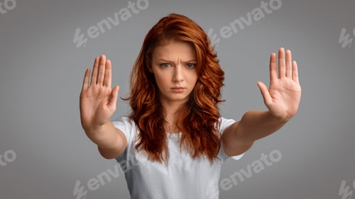 Preview: Girl Gesturing Stop Frowning Looking At Camera On Gray Background