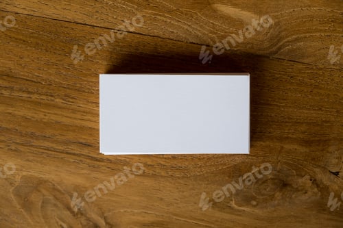 Preview: Top view image of stack of business card on wooden table background