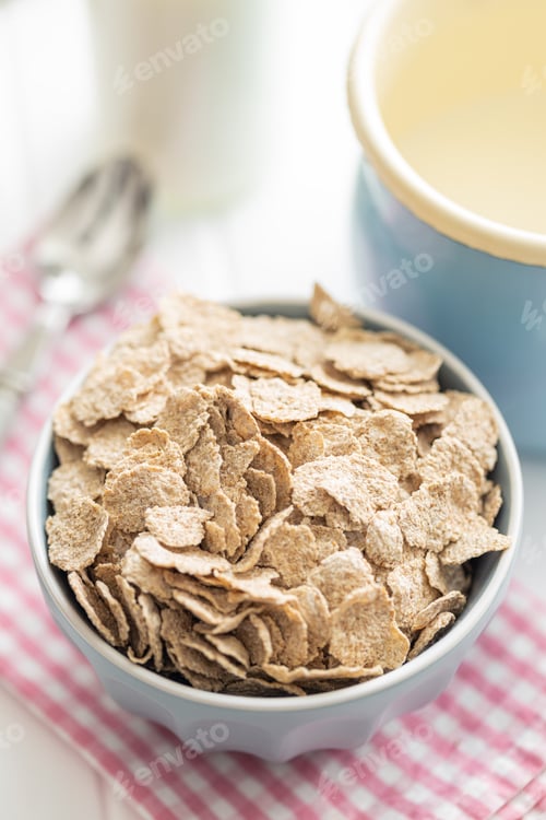 Preview: Whole grain cereal flakes. Wholegrain breakfast cereals in bowl on kitchen table.