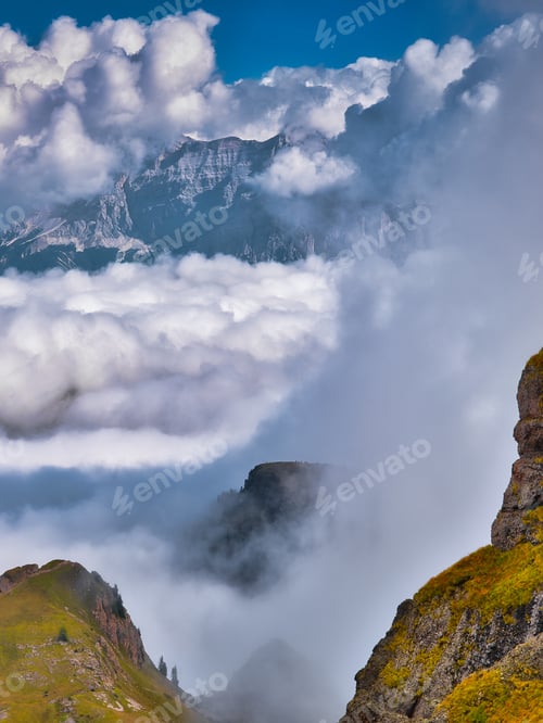 Preview: View of the mountains between the clouds in the Dolomites, Italy