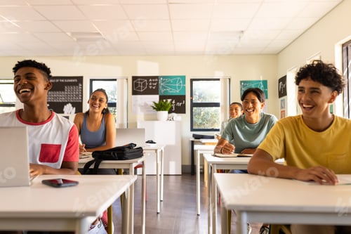 Preview: Teenagers in high school classroom, sitting at desks and smiling, enjoying lesson