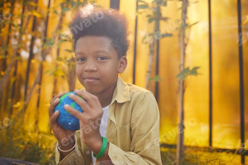Preview: African-American Boy Holding Planet