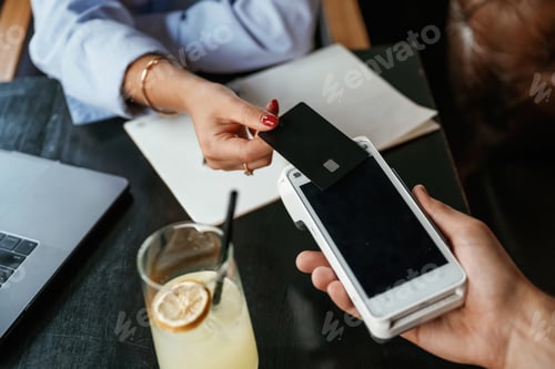 Preview: Money transfer. Woman is paying for the service in the restaurant