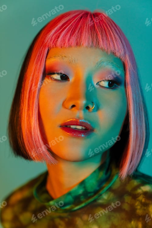 Preview: Asian girl with pink hair and piercing posing while looking aside